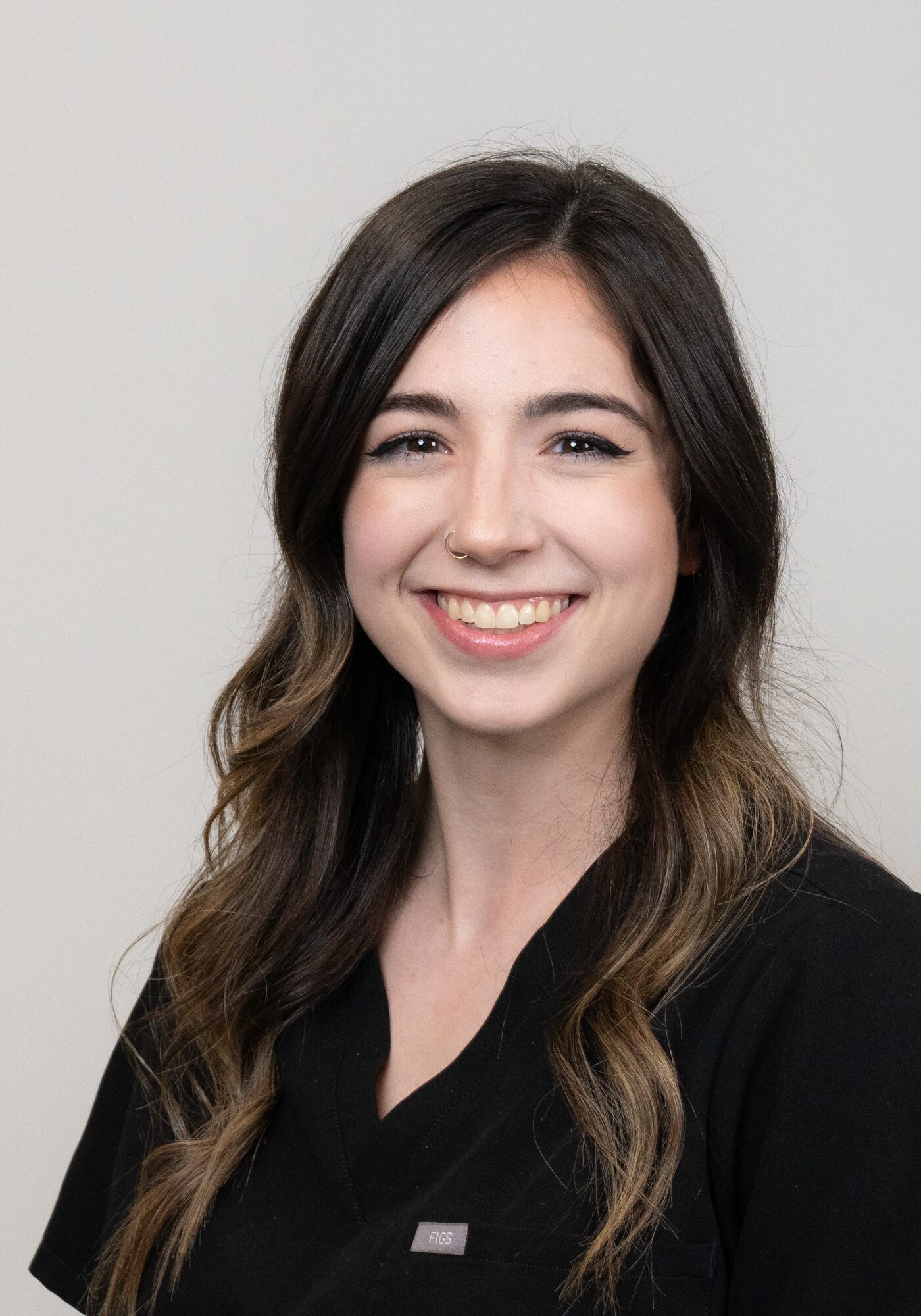 Allison, smiling orthodontic tech wearing black scrubs, representing Hoagburg Orthodontics team.
