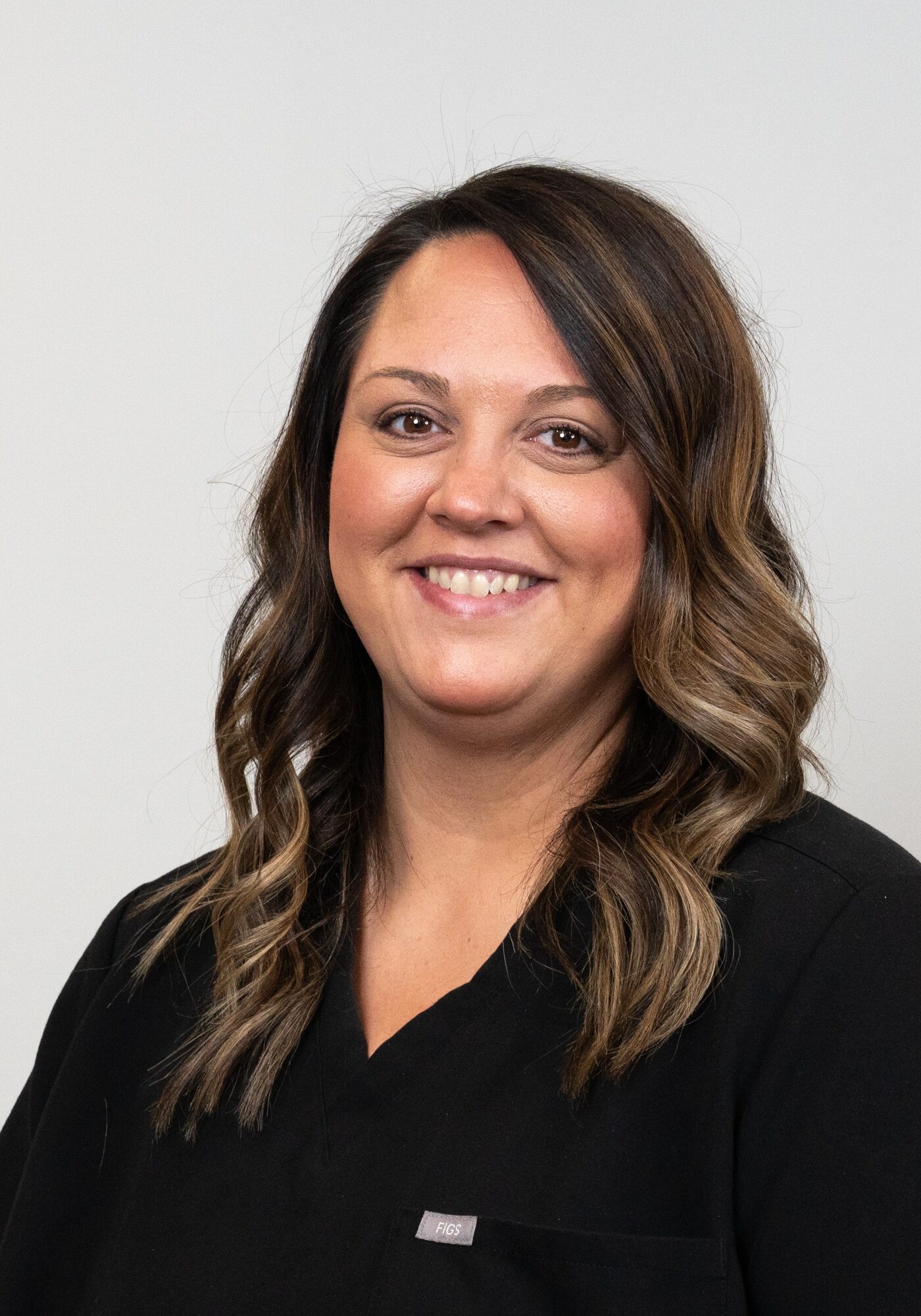 Alyssa, orthodontic technician at Hoagburg Orthodontics, smiling in professional attire against a neutral background.