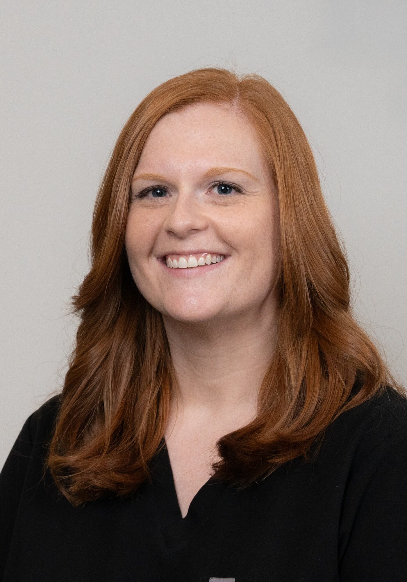 Orthodontic Tech Barbara smiling in a black uniform, representing the friendly team at Hoagburg Orthodontics, dedicated to exceptional orthodontic care.