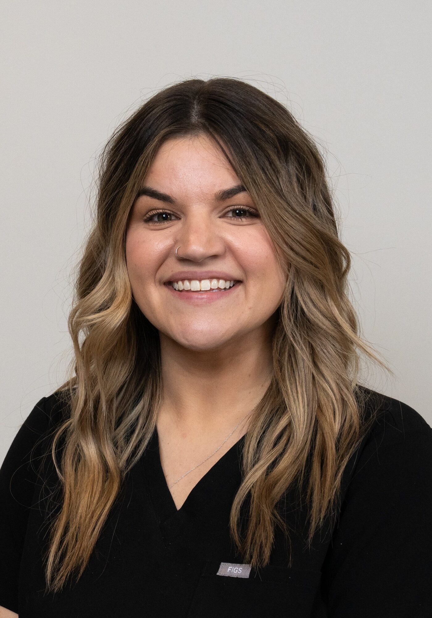 Fran, Financial Coordinator at Hoagburg Orthodontics, smiling in a black scrubs top, showcasing commitment to exceptional orthodontic care.